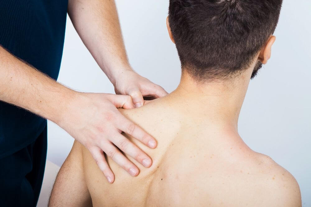 physical therapist performing manual therapy on shoulder